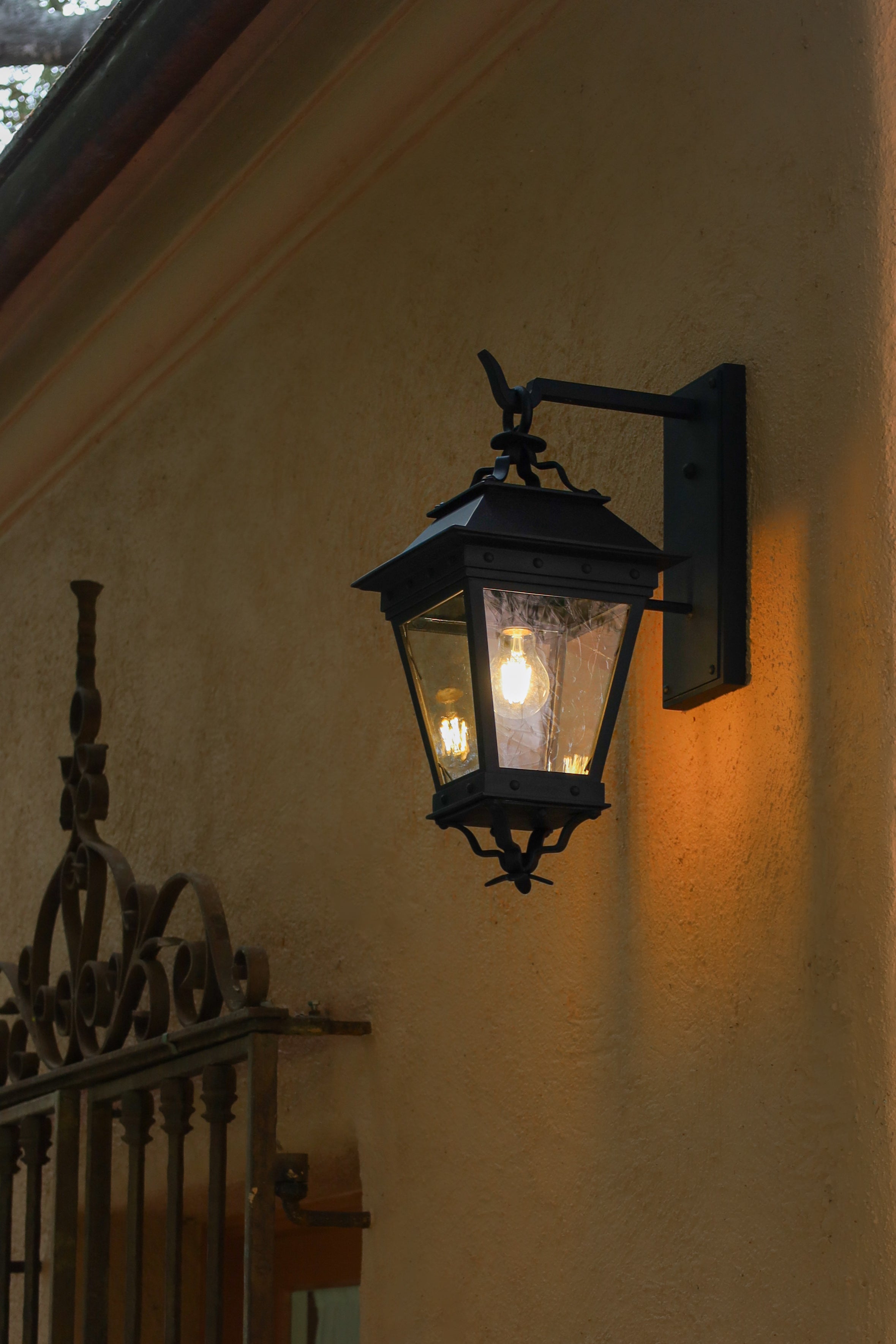 Vintage style, antique glass handmade outdoor light fixture on spanish style building