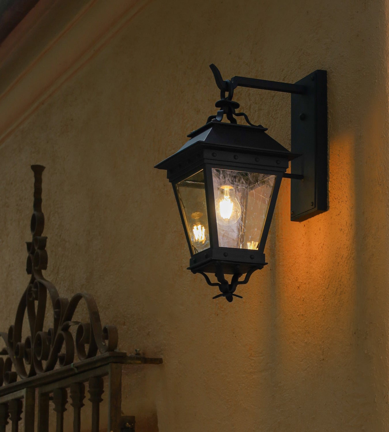 Vintage-style wall lamp on a textured wall with warm glow